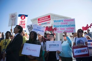 Demonstrators protest outside the U.S. Supreme Court in Washington, DC, Oct. 3, 2017, as the court hears arguments against gerrymandering.(Credit: Jim Watson / AFP / Getty Images)