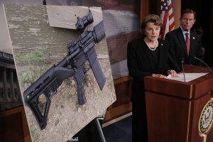 Sen. Dianne Feinstein (D-CA) and Sen. Richard Blumenthal (D-CT) show a photograph of a rifle with a 'bump stock' during a news conference to announce proposed gun control legislation at the U.S. Capitol October 4, 2017 in Washington, DC. (Credit: Chip Somodevilla/Getty Images)