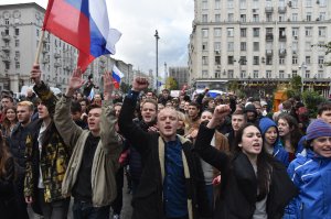 Demonstrators walk along Tverskaya Street during an unauthorized anti-Kremlin rally called by opposition leader Alexei Navalny, who is serving a 20-day jail sentence, in downtown Moscow on Oct. 7, 2017, President Vladimir Putin's 65th birthday. (Credit: Vasily Maximov / AFP / Getty Images)