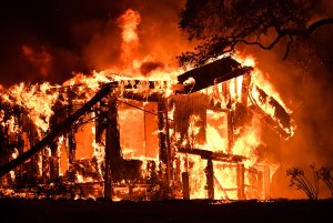 Flames ravage a home in the Napa wine region in California on Oct. 9, 2017, as multiple wind-driven fires continue to whip through the region. (Credit: Josh Edelson / AFP / Getty Images)