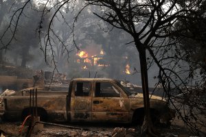 Fire consumes a home as an out of control wildfire moves through the area on Oct. 9, 2017, in Glen Ellen, California. (Credit: Justin Sullivan / Getty Images)