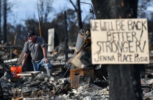 A resident takes pause while searching through debris at his burned home in Santa Rosa on Oct. 20, 2017. (Credit: Josh Edelson / AFP / Getty Images)