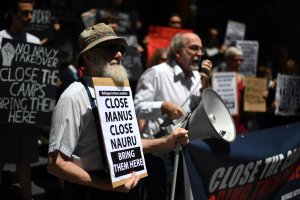 Refugee advocates protest against the closing of asylum-seeker camps in Papua New Guinea, in front of the Sydney Commonwealth government offices on Oct. 31, 2017, as they demand the resettlement of the refugees to Australia.(Credit: Saeed Khan/AFP/Getty Images)