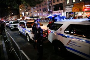NYPD officers stand guard during the annual Halloween parade after a man driving a rental truck struck and killed 8 people on a jogging and bike path in Lower Manhattan on Oct. 31, 2017, in New York City. (Credit: Kena Betancur/Getty Images)