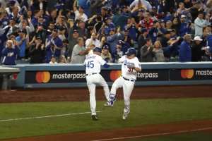 Joc Pederson #31 of the Los Angeles Dodgers celebrates with third base coach Chris Woodward after hitting a solo home run during the seventh inning against the Houston Astros in Game 6 of the 2017 World Series at Dodger Stadium on Oct. 31, 2017, in Los Angeles. (Credit: Christian Petersen/Getty Images)