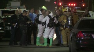 A hazmat crew responds after a woman and two children were found covered in white powder in South L.A. on Oct. 19, 2017. (Credit: KTLA)