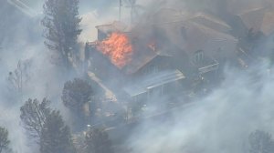 A home burns in Anaheim Hills on Oct. 9, 2017. (Credit: KTLA)