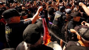 Chaos broke out outside the Republican National Convention in Cleveland on July 20, 2016, when a group of far-left protesters burned an American flag. Riot police moved in to arrest them. (Credit: Carolyn Cole / Los Angeles Times)