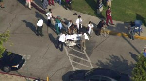 A patient is shown being wheeled out of the Olive View UCLA Medical Center after reports of a man with a gun on October 19, 2017. (Credit: KTLA)