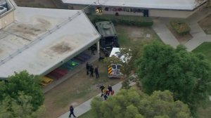 A person was placed into an ambulance after an hourslong hostage situation at a school in Riverside on Oct. 31, 2017. (Credit: KTLA)