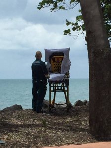 A dying woman is wheeled out to the ocean in a photo uploaded by the Queensland Ambulance Service to Facebook on Nov. 23, 2017.