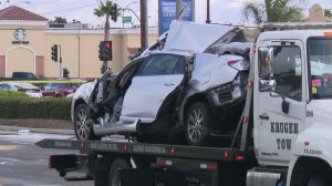 A mangled car involved in a crash in Carson on Nov. 5, 2017 is towed away from the scene of the crash. (Credit: Loudlabs)