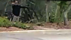 A man in a black shirt is seen aiming a bow and arrow in surveillance footage taken on Sept. 14, 2017. (Credit: Robyn and Chuck Tapert)