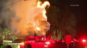 Flames and smoke are seen during a house fire in Downey on Nov. 18, 2017. (Credit: LOUDLABS)