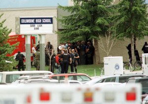 Police stand outside the east entrance of Columbine High shool as bomb squads and SWAT teams secure students 20 April 1999 in Littleton, Colorado. (Credit: MARK LEFFINGWELL/AFP/Getty Images)