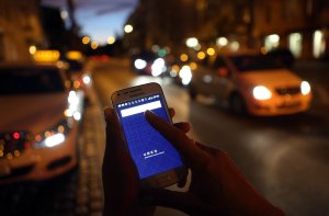 In this photo illustration, a woman uses the Uber app on Sept. 2, 2014, in Berlin, Germany. (Credit: Adam Berry / Getty Images)