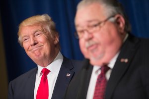 Republican presidential candidate Donald Trump listens as Sam Clovis speaks at a press conference on Aug. 25, 2015, in Dubuque, Iowa. (Credit: Scott Olson / Getty Images)