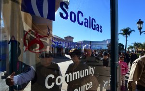 A security guard gestures the way in for Porter Ranch residents arriving at the SoCal Gas Community Resource Center in Porter Ranch, California on Jan. 8, 2016. (Credit: FREDERIC J. BROWN/AFP/Getty Images)
