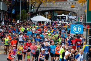 Runners make the turn onto First Avenue after crossing the Queensboro Bridge during the 2016 TCS New York City Marathon, November 6, 2016 in New York City. (Credit: Drew Angerer/Getty Images)