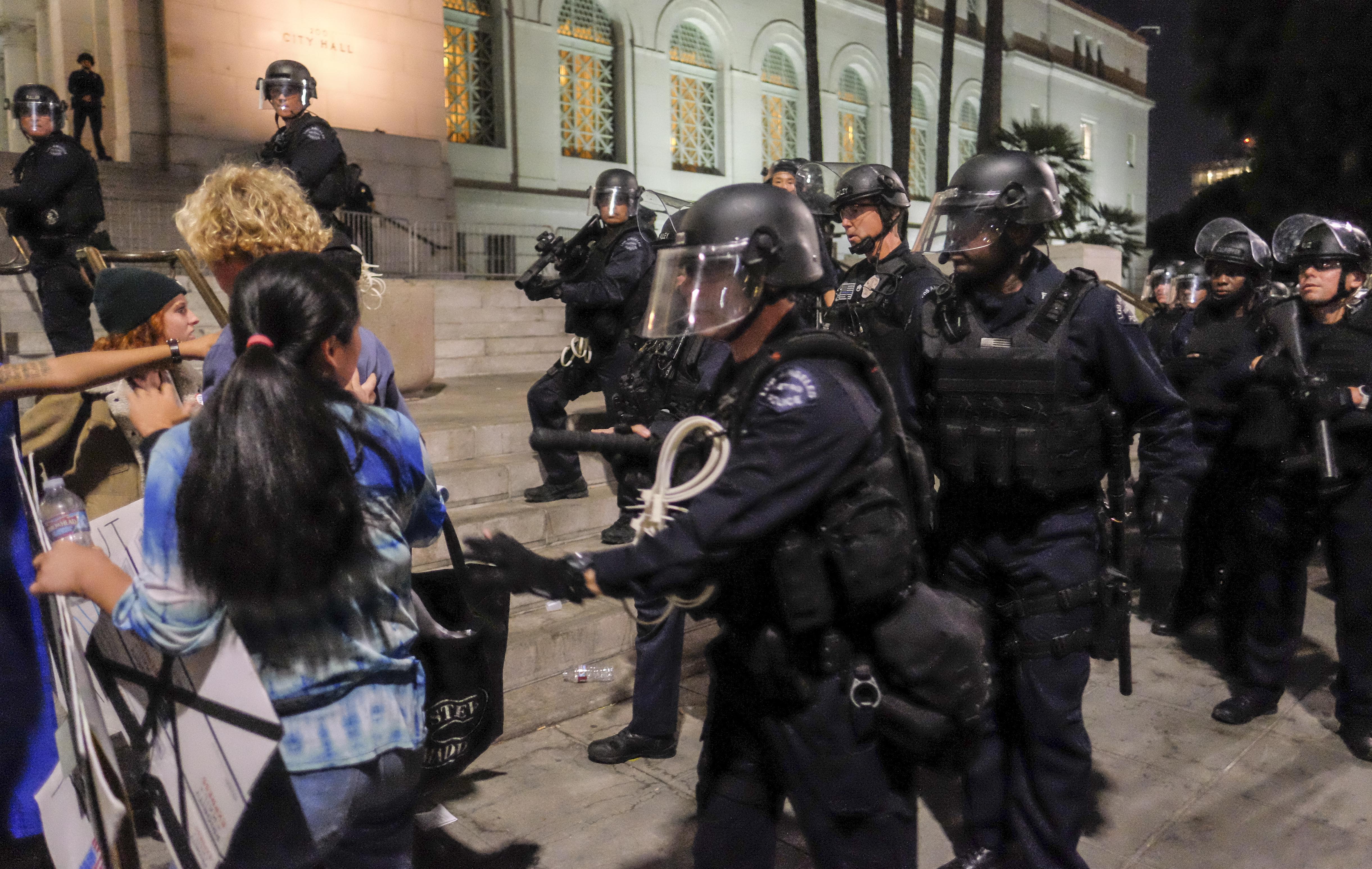 Police in riot gear confront demonstrators outside City Hall during a protest against President-elect Donald Trump in Los Angeles on Nov. 13, 2016. (Credit: RINGO CHIU/AFP/Getty Images)