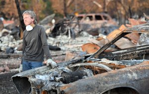 Car collector Gary Dower speaks with neighbors at his fire-destroyed home in Santa Rosa, California on Oct. 20, 2017. (Credit: Josh Edelson / AFP / Getty Images)