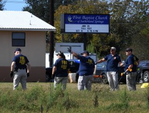 FBI agents search for clues at the entrance to the First Baptist Church, after a mass shooting that killed 26 people in Sutherland Springs, Texas on November 6, 2017. (Credit: Mark Ralston/AFP/Getty Images)