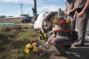 Police move flowers placed at a barricade near the First Baptist Church of Sutherland Springs on Nov. 6, 2017. in Sutherland Springs, Texas. (Credit: Scott Olson/Getty Images)