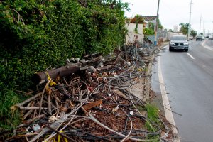 Power line poles and lines downed by the passing of Hurricane Maria lie on a sidewalk in San Juan, Puerto Rico on Nov. 7, 2017. (Credit: Ricardo Arduengo / AFP / Getty Images)