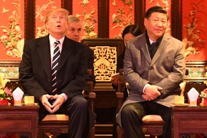 US President Donald Trump (L) looks up as he sits beside China's President Xi Jinping during a tour of the Forbidden City in Beijing on November 8, 2017. (Credit: JIM WATSON/AFP/Getty Images)