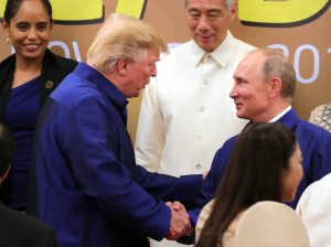 Donald Trump shakes hands with Russia's President Vladimir Putin as they pose for a group photo ahead of the Asia-Pacific Economic Cooperation Summit in Da Nang, Vietnam on Nov. 10, 2017. (Credit: Mikhail Klimentyev/AFP/Getty Images)