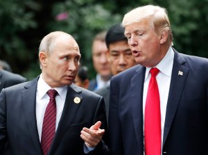 US President Donald Trump (right) and Russia's President Vladimir Putin talk as they make their way to take the "family photo" during the Asia-Pacific Economic Cooperation leaders' summit in the central Vietnamese city of Danang on Nov. 11, 2017. (Credit: Jorge Silva /AFP/Getty Images)