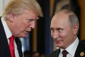President Donald Trump chats with Russian President Vladimir Putin as they attend the APEC Economic Leaders' Meeting in Danang, Vietnam, on Nov. 11, 2017. (Credit: Mikhail Klimentyev / AFP / Getty Images)