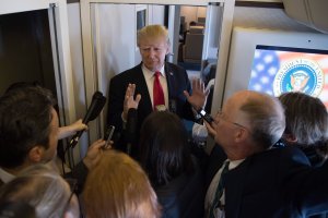U.S. President Donald Trump speaks to the media onboard Air Force One after departing from Danang on his way to Hanoi, Nov. 11, 2017. (Credit: Jim Watson / AFP / Getty Images)