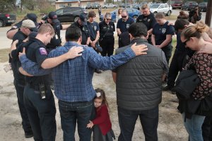 First responders share a prayer following a Veterans Day ceremony outside the community center in Sutherland Springs, Texas, on Nov. 11, 2017. (Credit: Scott Olson / Getty Images)