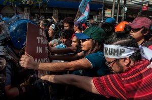 Protesters clash with riot police as they march in the streets of Manila on the day of U.S. President Trump's arrival on Nov. 12, 2017, in Manila, Philippines. (Credit: Jes Aznar / Getty Images)