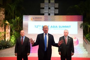 U.S. President Donald Trump gestures to the press as U.S. National Security Advisor HR McMaster, left, and U.S. Secretary of State Rex Tillerson look on after attending the ASEAN Summit in Manila on Nov. 14, 2017. (Credit: Jim Watson / AFP / Getty Images)