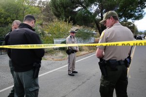 Law enforcement officers stand near one of many crime scenes after a shooting on Nov. 14, 2017, in Rancho Tehama, California. (Credit: Elijah Nouvelage / AFP / Getty Images)