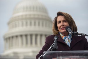 U.S. House Democratic Leader Nancy Pelosi speaks to demonstrators as they protest against the Republican tax reform plan on Capitol Hill, Nov. 15, 2017. (Credit: Saul Loeb / AFP / Getty Images)