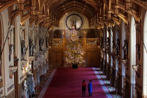 Employees pose with a 20-foot Nordmann Fir tree in St. George's Hall, which has been decorated for the Christmas, on Nov. 23, 2017, in Windsor Castle, England. (Credit: Jack Taylor / Getty Images)