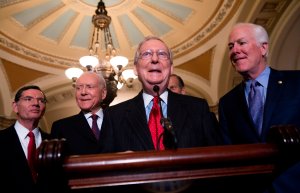 Senate Majority Leader Mitch McConnell alongside Senate Majority Whip John Cornyn (far right), Sen. John Barrasso (left) and Sen. Orrin Hatch (second left), speaks after a meeting between President Donald Trump and the Republican Senate Caucus in Washington, DC, Nov. 28, 2017. (Credit: Saul Loeb / AFP / Getty Images)