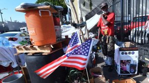 Flags are hoisted at the street-corner encampment of L.A. homeless veteran Kendrick Bailey. (Frederic J. Brown / AFP/Getty Images)