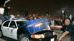 Unruly Lakers fans damage a police car in front of the Staples Center after the Lakers won the NBA championship in 2009. (Credit: Gina Ferazzi / Los Angeles Times)