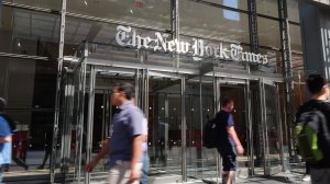 Pedestrians walk by the outside The New York Times building on June 30, 2016 in New York City. (Credit: Mike Coppola/Getty Images)