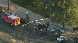 A man is being treated after an officer-involved shooting in Van Nuys on Nov. 15, 2017. (Credit: KTLA)