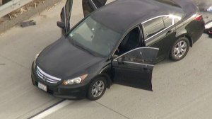 Bullet holes are seen in a car on the 210 Freeway in Fontana on Nov. 16, 2017. (Credit: KTLA)