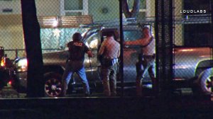 Authorities approach a pickup truck during a standoff in South Gate on Nov. 27, 2017. (Credit: Loudlabs)
