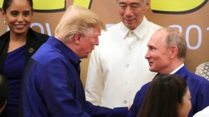 Donald Trump shakes hands with Russia's President Vladimir Putin as they pose for a group photo ahead of the Asia-Pacific Economic Cooperation Summit in Danang, Vietnam on Nov. 10, 2017. (Credit: Mikhail Klimentyev/AFP/Getty Images)