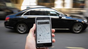 A photo illustration shows a phone displaying the Uber ride-hailing app on Sept. 22, 2017, in London, England. (Credit: Leon Neal/Getty Images)