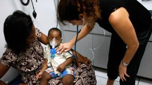 University of Miami Pediatrician, Dr. Gwen Wurm, does a checkup on D'Acquel Emmanuel Sema, 13-moths-old, as he is held by his mother, Adelaide Sema at the University of Miami Pediatric clinic on Oct. 3, 2007, in Miami, Fla. Then-U.S President George W. Bush vetoed a bipartisan bill that would have dramatically expanded children's health insurance through the Children's Health Insurance Program , or CHIP, a joint state-federal effort that subsidizes health coverage for 6.6 million people, mostly children. (Credit: Joe Raedle/Getty Images)