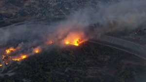 Smoke and flames rise from the Creek Fire near the Hansen Dam on Dec. 5, 2017. (Credit: KTLA)